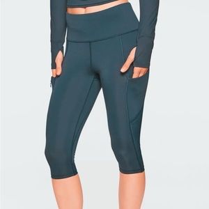 Athleta all In crop leggings. Deep teal. Mesh cutouts. Pockets on side